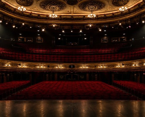 Empty theatre auditorium with stage lighting, UK