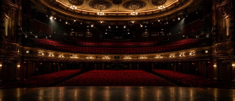 Empty theatre auditorium with stage lighting, UK