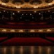 Empty theatre auditorium with stage lighting, UK