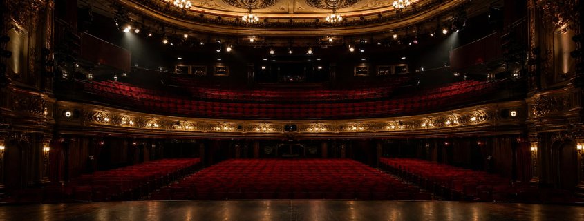 Empty theatre auditorium with stage lighting, UK